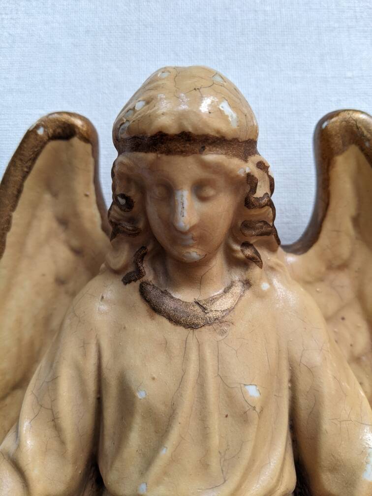 Antique ceramic holy water font with winged angel, religious object, country decoration