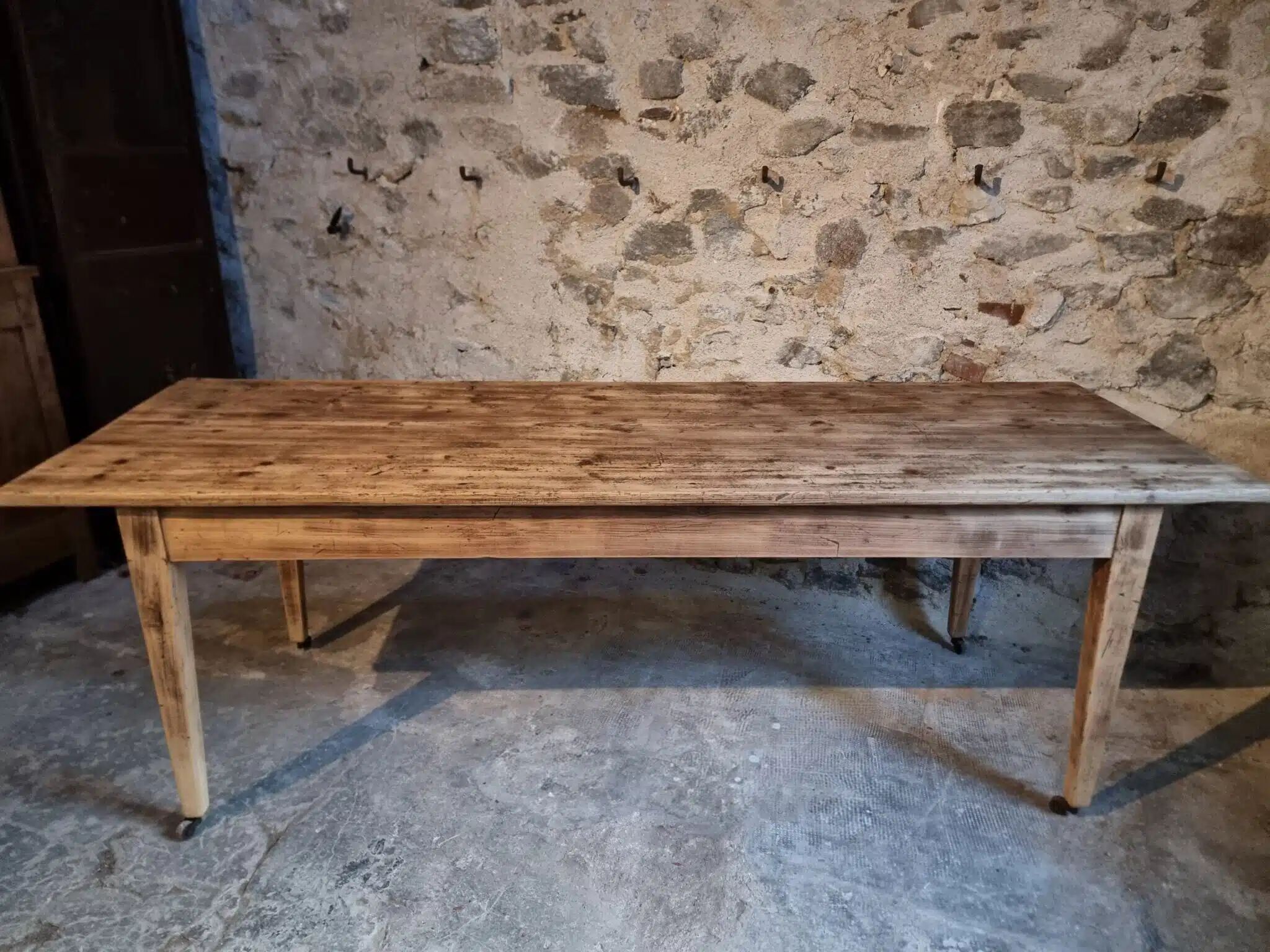 Antique French pine dining table, large farmhouse table on wheels, 19th century.