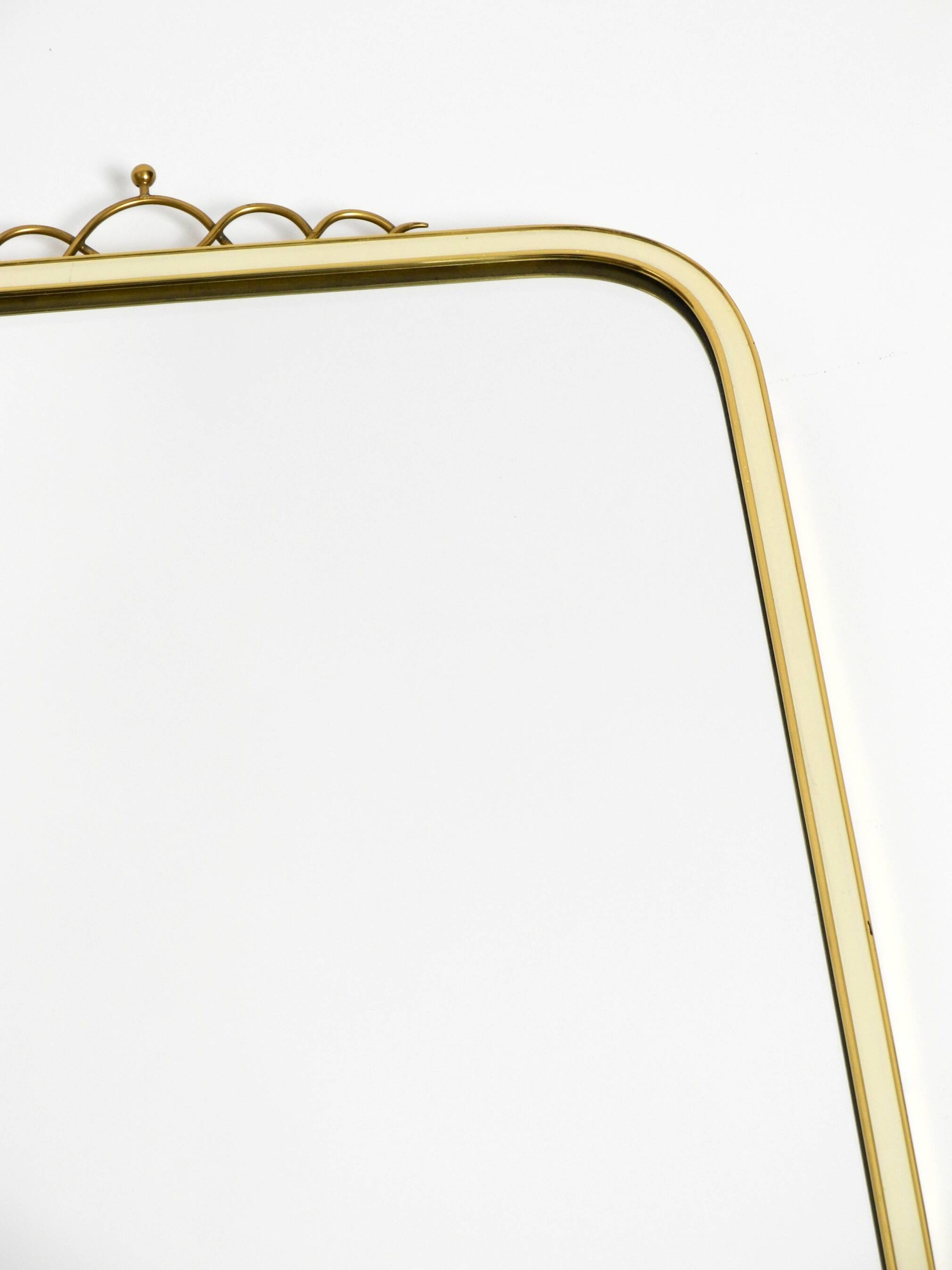 Large heavy long Mid Century brass wall mirror by Münchner Zierspiegel