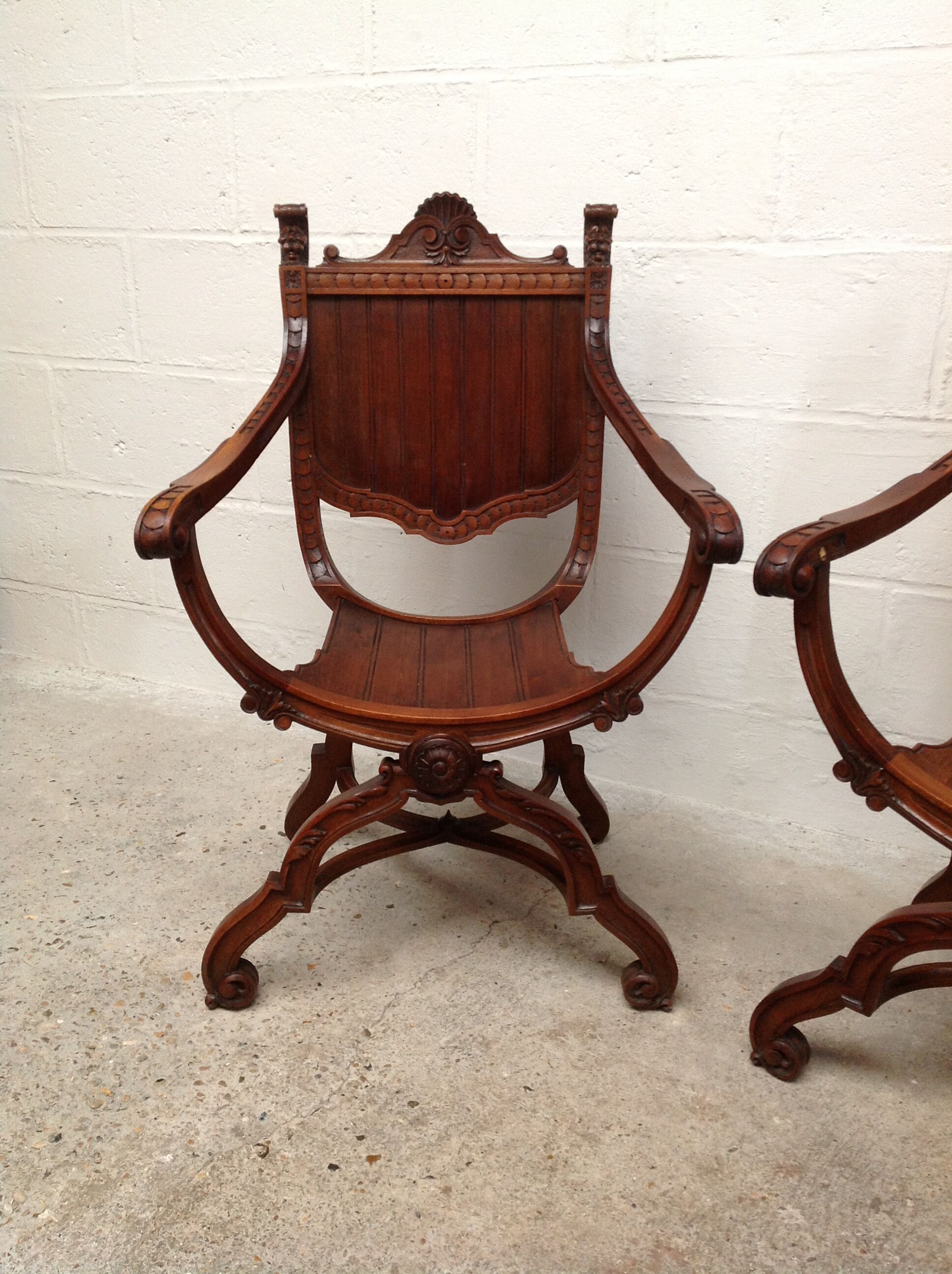 Pair of antique armchairs curules called Dagobert in carved wood
