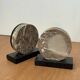 Vintage pair of bookends in fossilised coral agate | Stone disc-shaped bookends on a black marble base