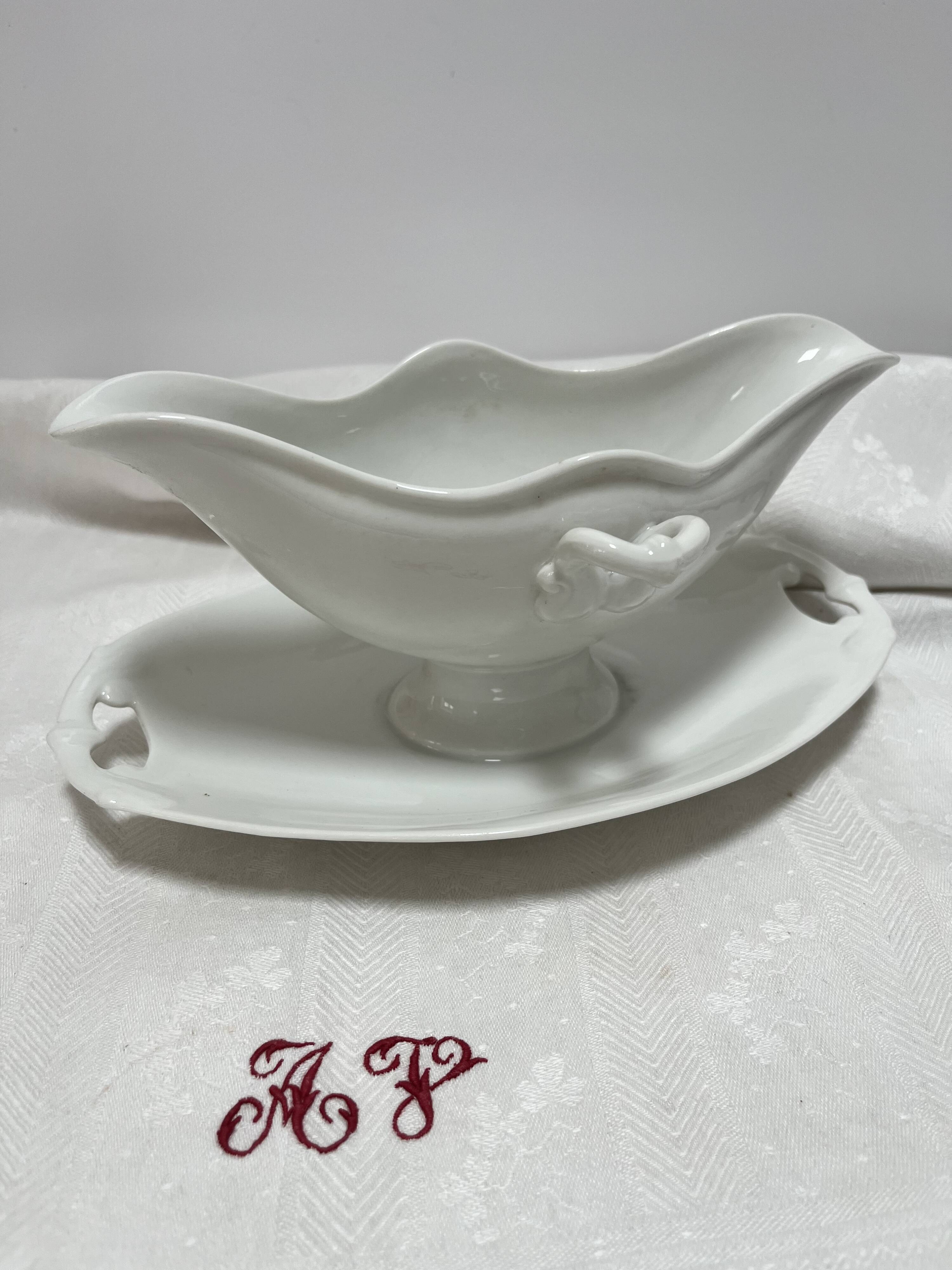White porcelain sauce boat on tray