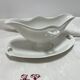 White porcelain sauce boat on tray