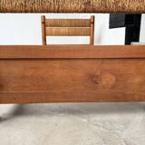 Brutalist style bed with chain and straw