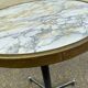 Round bistro table with a central pedestal, gold marble effect and black steel, 60cm.
