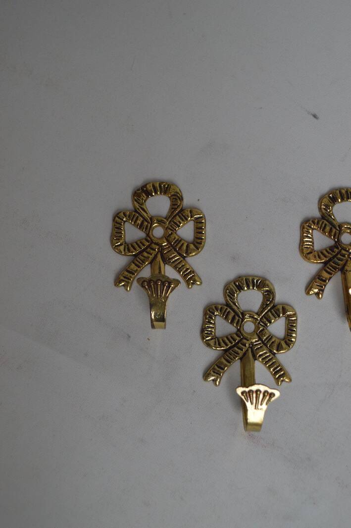 Trio of brass coat hooks