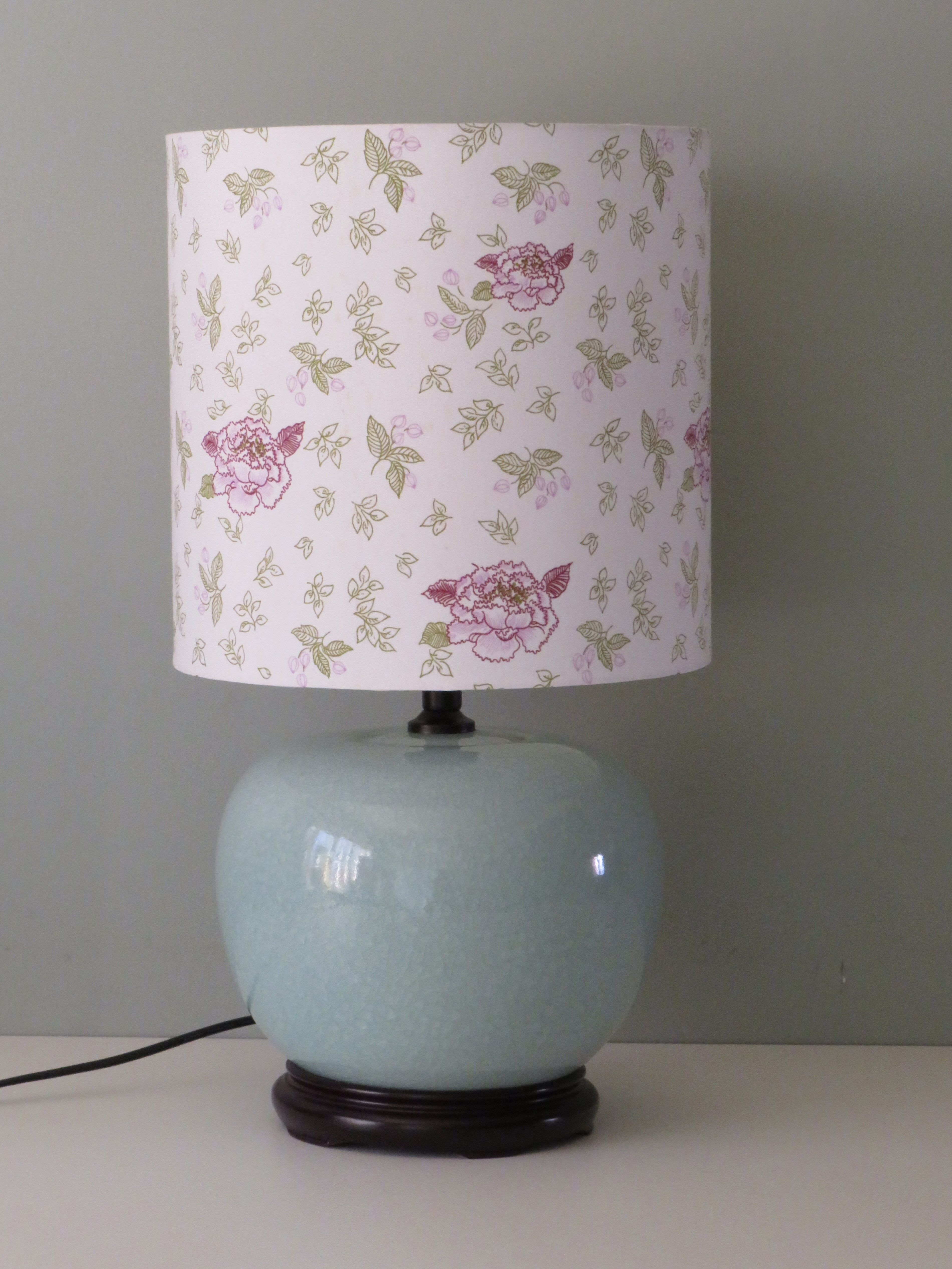 Celadon-colored cracked ceramic table lamp with new personalized lampshade.