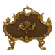 Large gilded bronze fireplace screen decorated with putti and rocaille motifs.