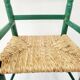 Small vintage children's chair in wood and green straw