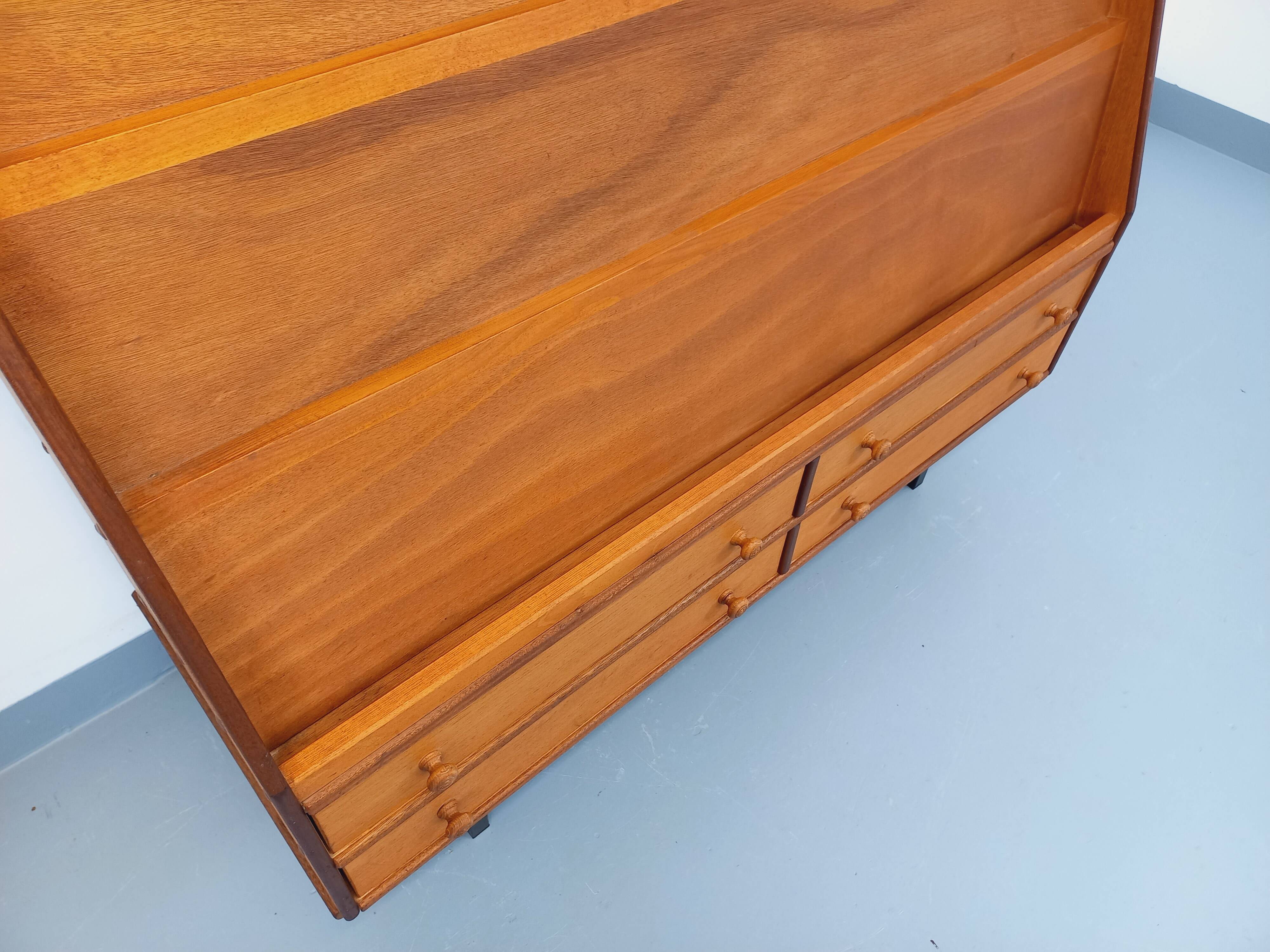 Vintage wooden display bookshelf with drawers from the 1960s.