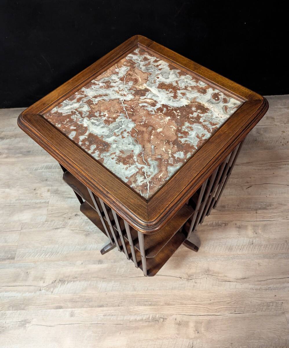 Rotating walnut library with a marble top.