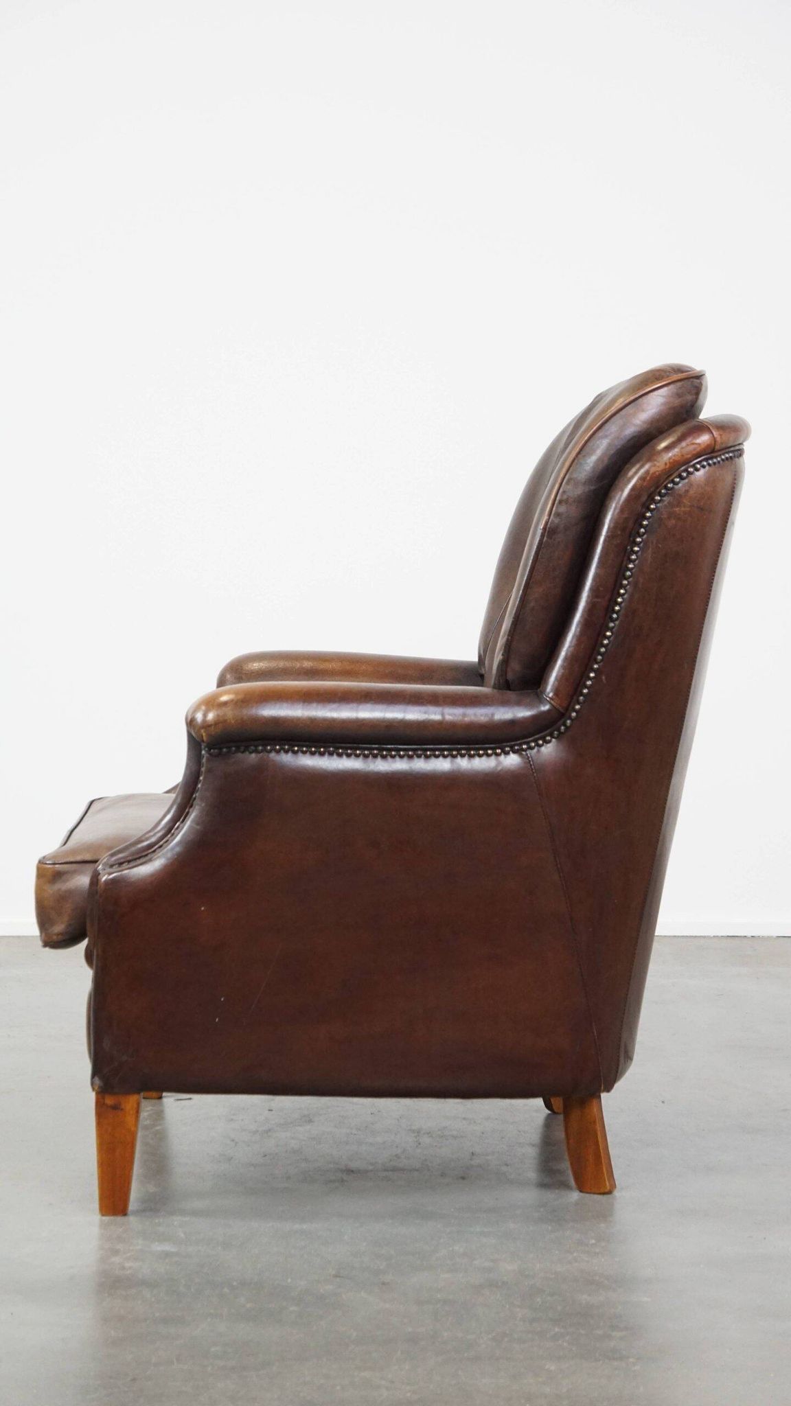 Vintage sheepskin armchair in a dark cognac colour with a comfortable seat