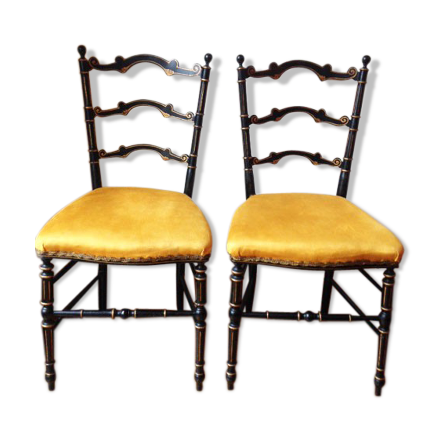 Pair of black and gold chairs