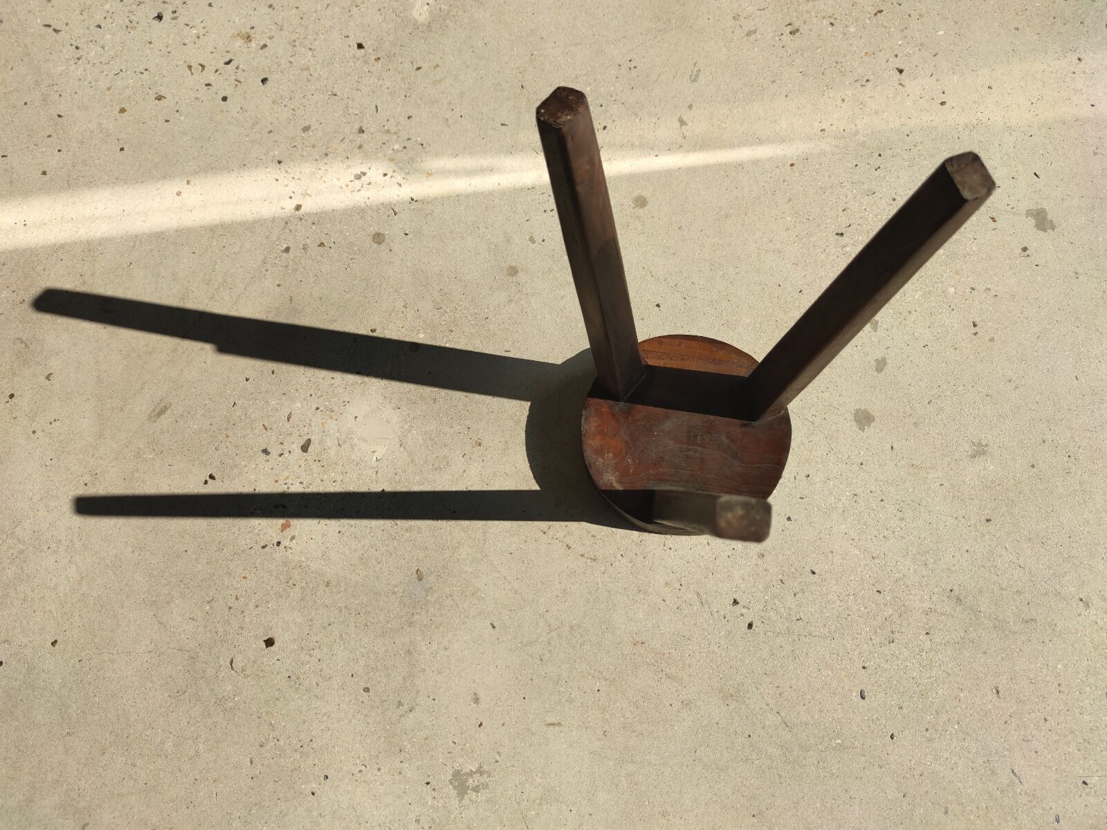 Small high tripod stool in brown solid wood