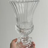 Antique thick glass vase on a pedestal.