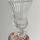 Antique thick glass vase on a pedestal.