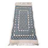 White and blue hand-woven rug in natural wool