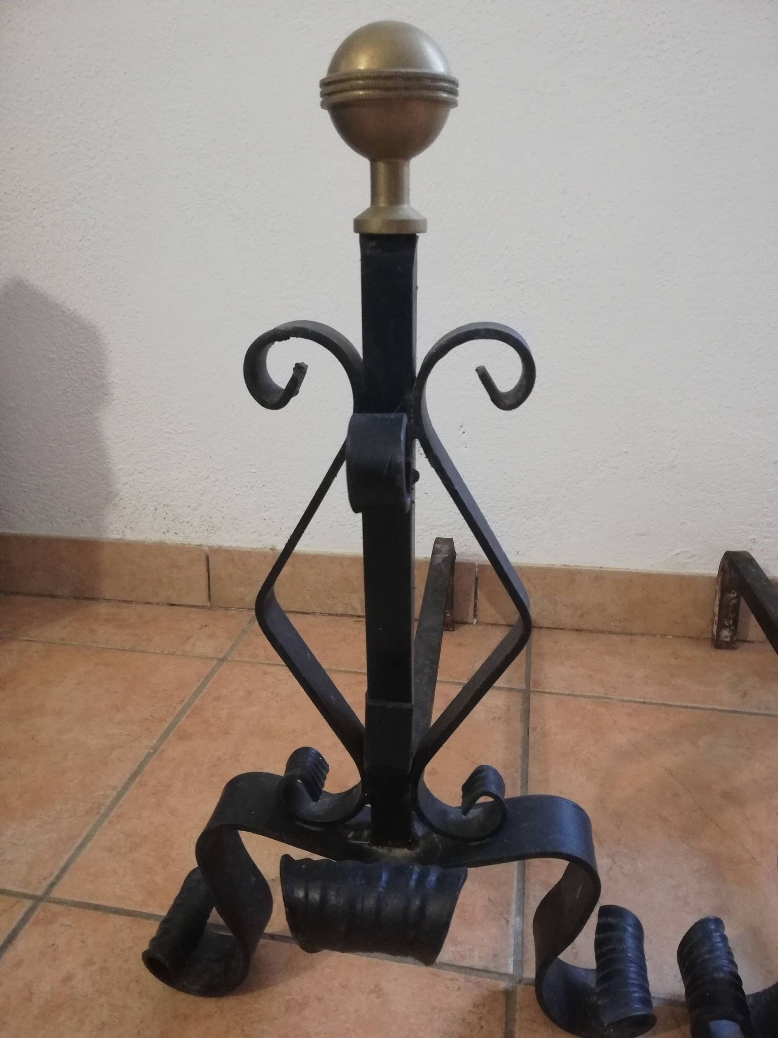 Pair of wrought iron andirons and brass ball.