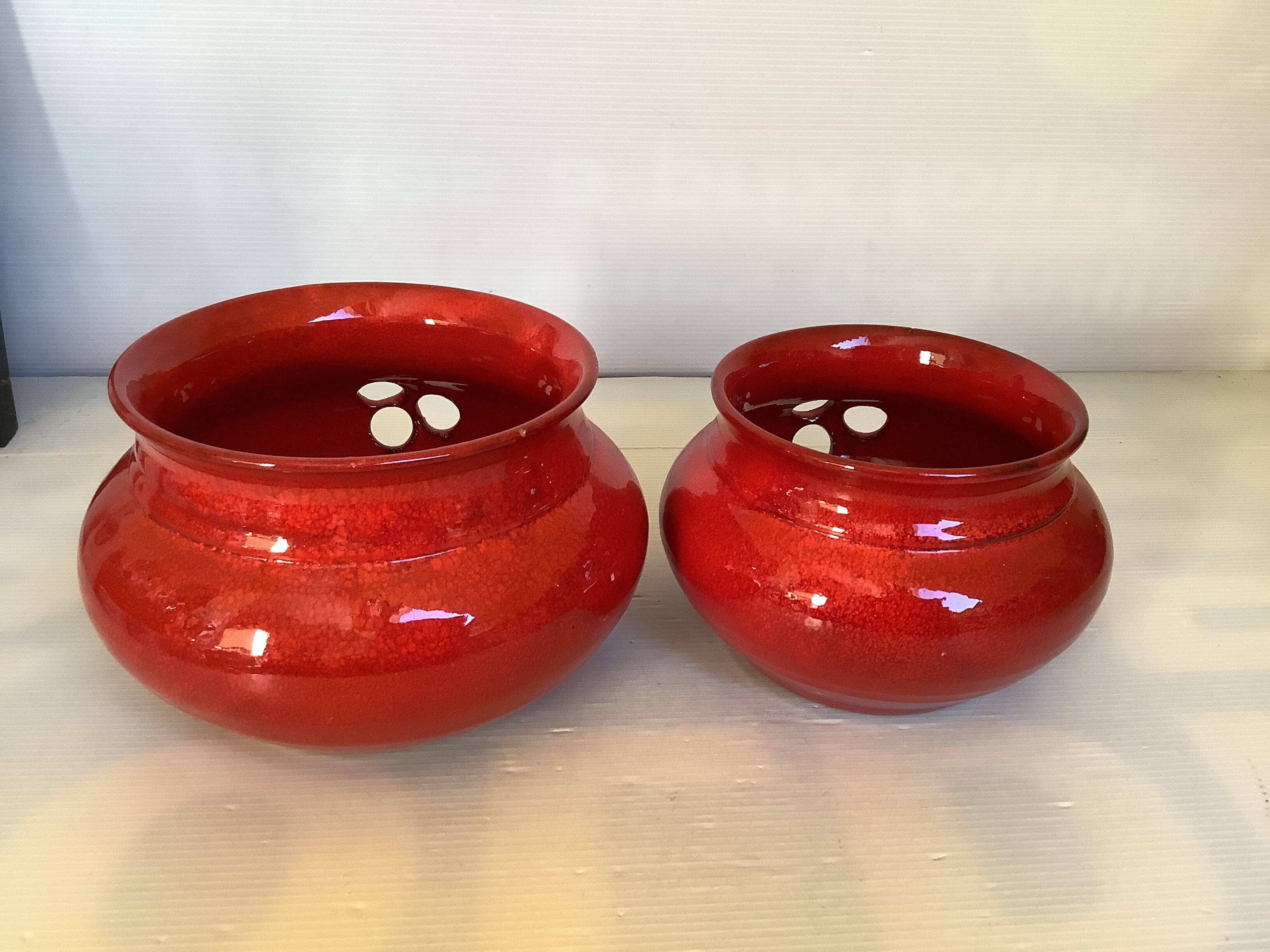 Pair of red Scandinavian candle holders.
