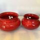 Pair of red Scandinavian candle holders.