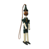 Green pinochio puppet in old wood