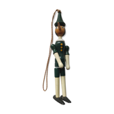 Green pinochio puppet in old wood