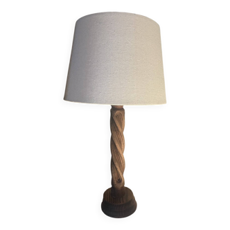Wooden floor lamp with white tweed shade.