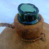 Demijohn dressed in burlap and padded cork