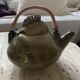 Handmade ceramic teapot with green fish and bamboo