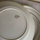 Set of 8 modernist flat plates in fine earthenware with pure gold trim, 1930.