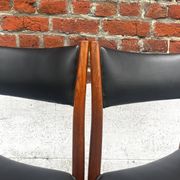 Set of 2 vintage Scandinavian chairs in wood and black faux leather.
