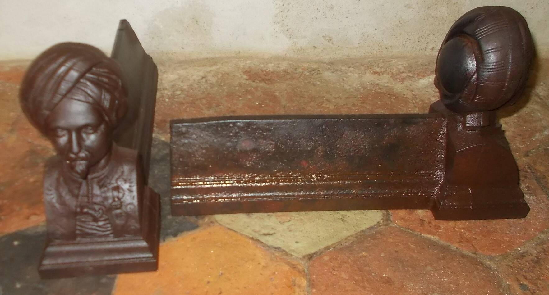 Old cast iron andirons with oriental decor