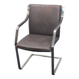 One of two vintage Leather and metal arm chairs.