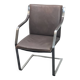 One of two vintage Leather and metal arm chairs.