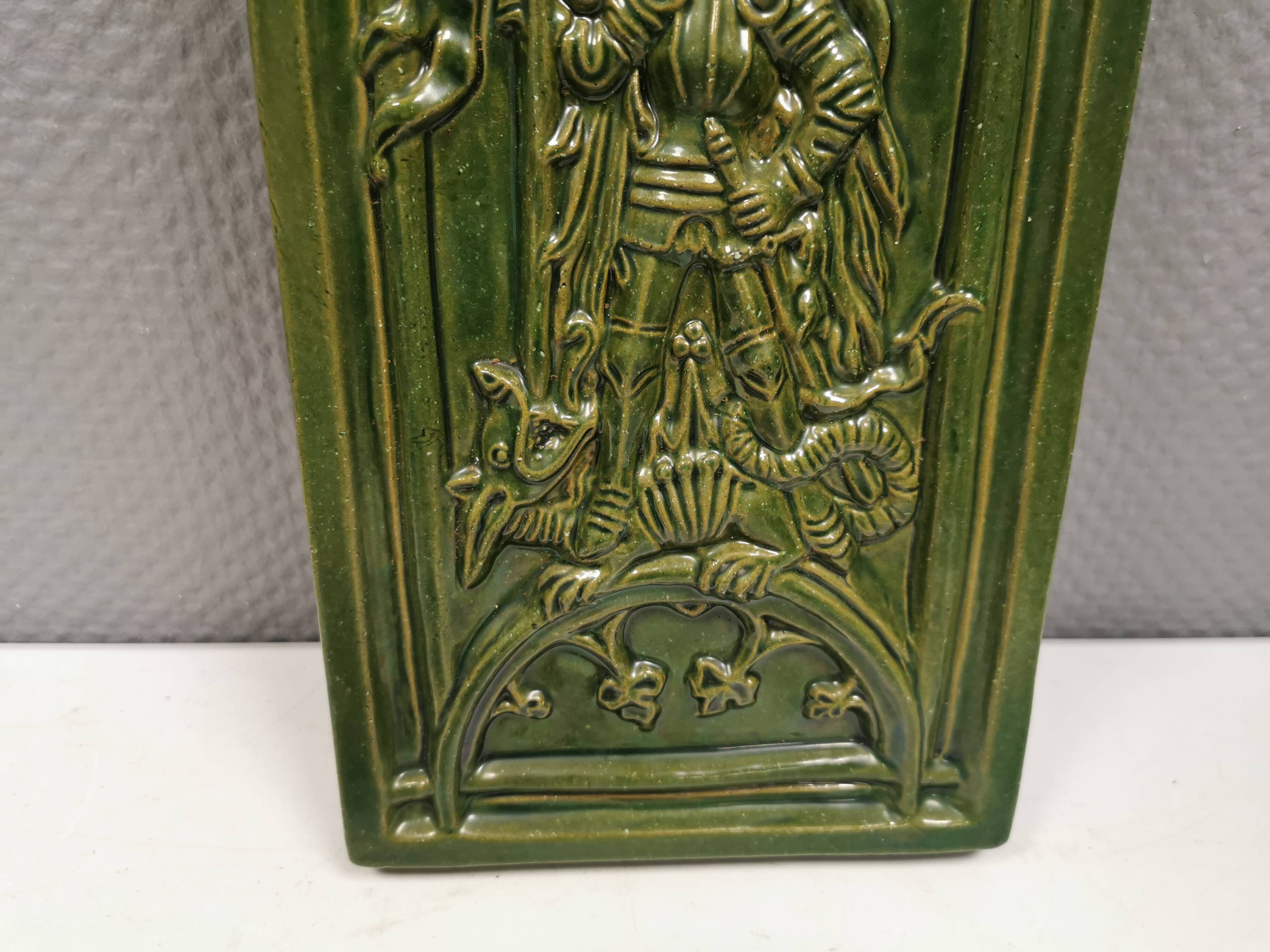 Antique tile in green faience, motif of Saint George and the dragon
