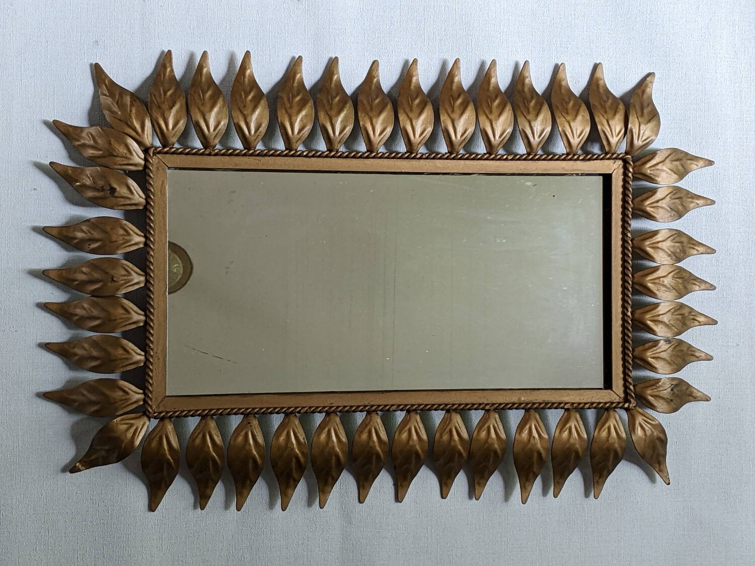 Vintage gold metal mirror with leaves from the 1950s.