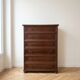 Brown antique-style wooden chest of drawers with 6 drawers.
