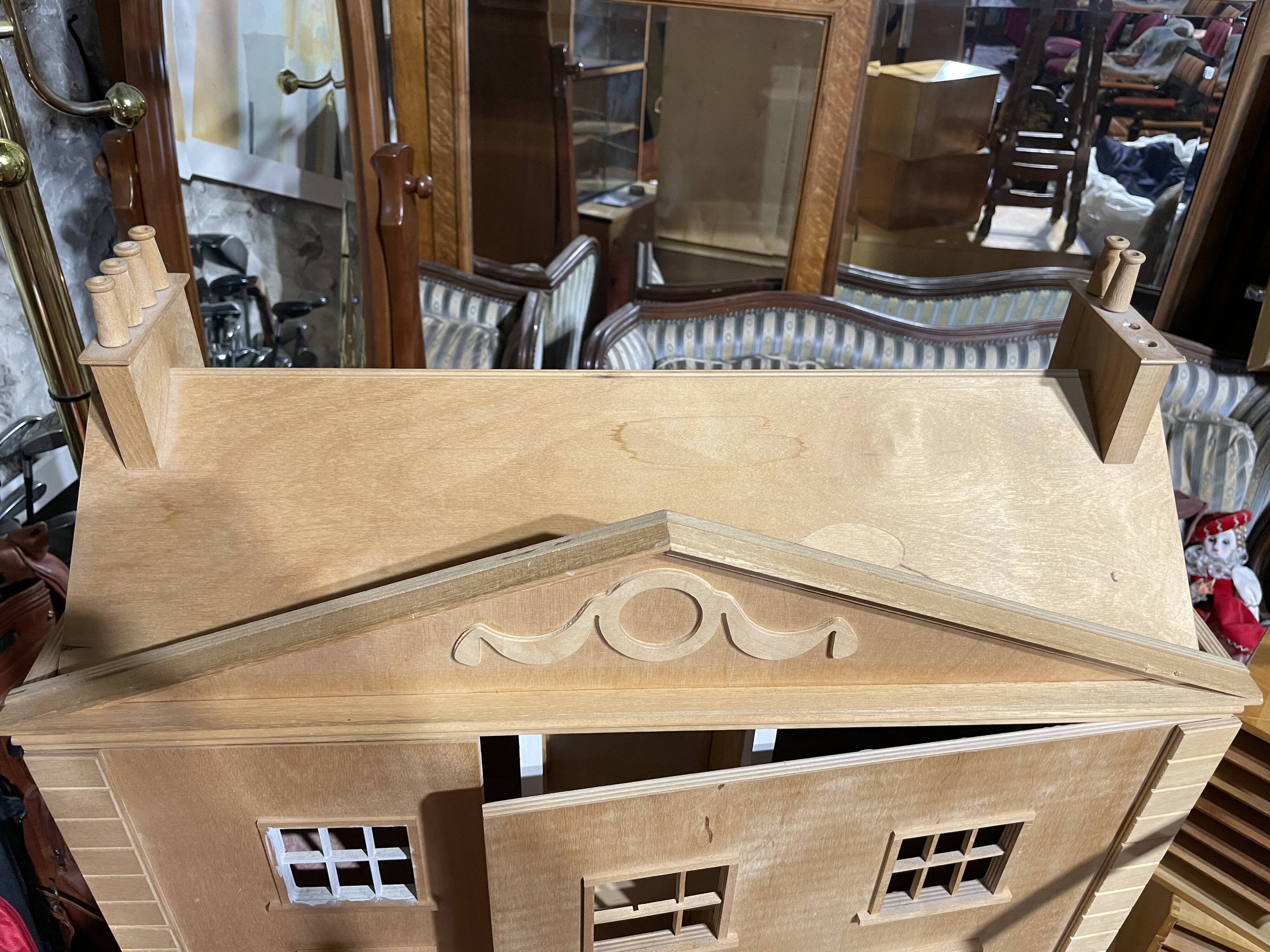Large wooden dollhouse with miniature furniture