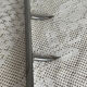 Stainless steel butcher's hook, known as a "wolf tooth bar."