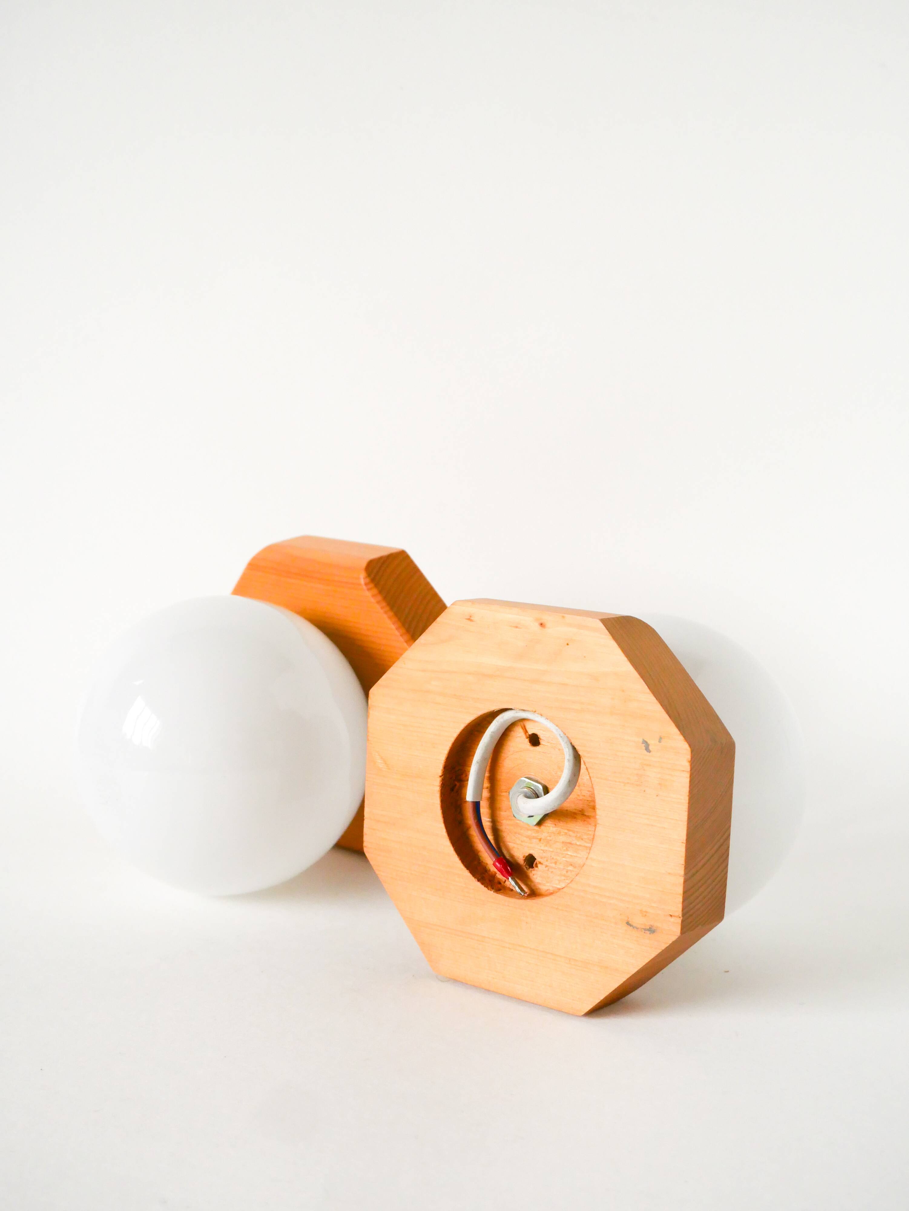 Pair of globe wall lights in opaline with a pine base, 1980.