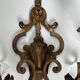 Pair of patinated wrought iron wall sconces with golden acanthus leaves and crystals.