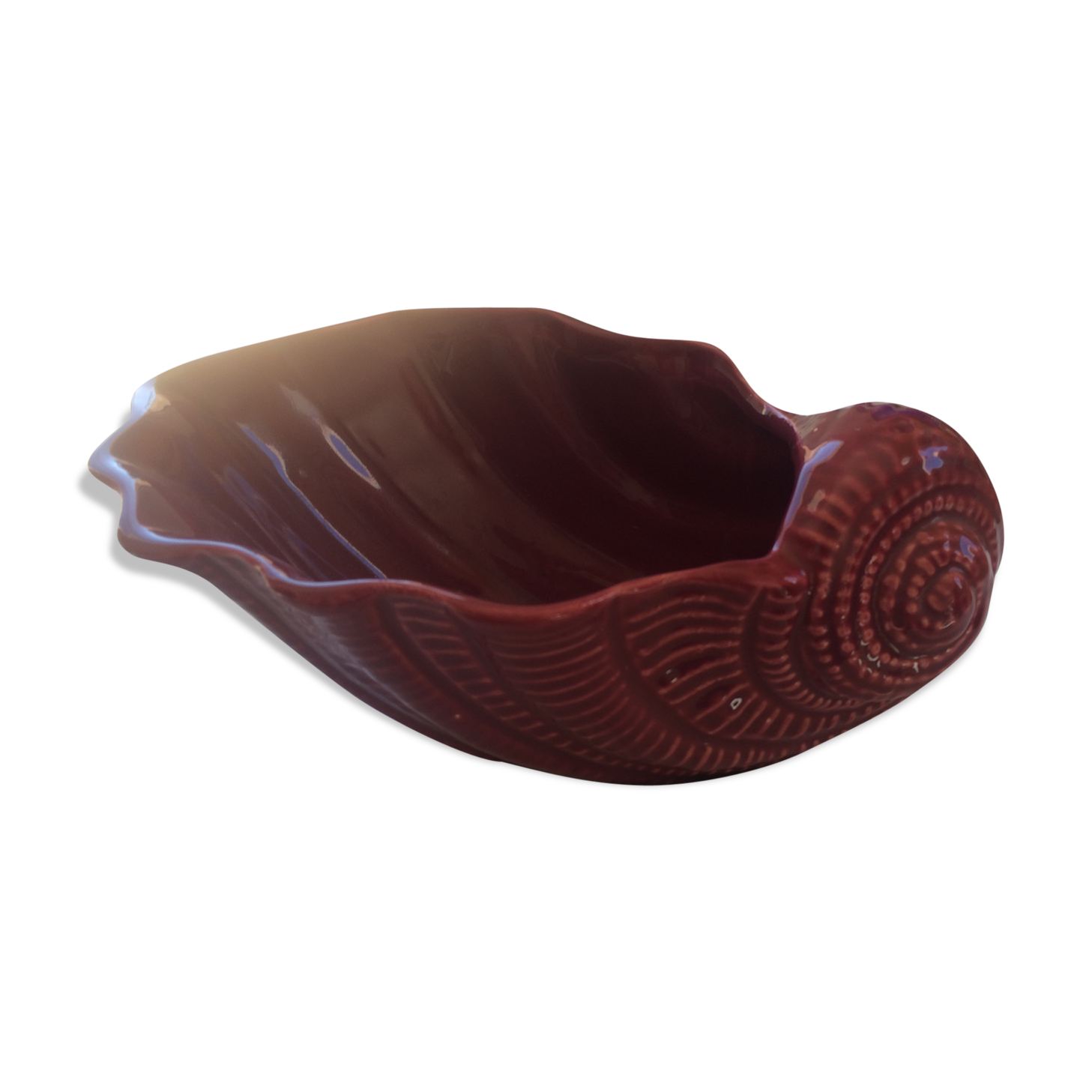 Empty red ceramic snail shaped pouch