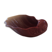 Empty red ceramic snail shaped pouch
