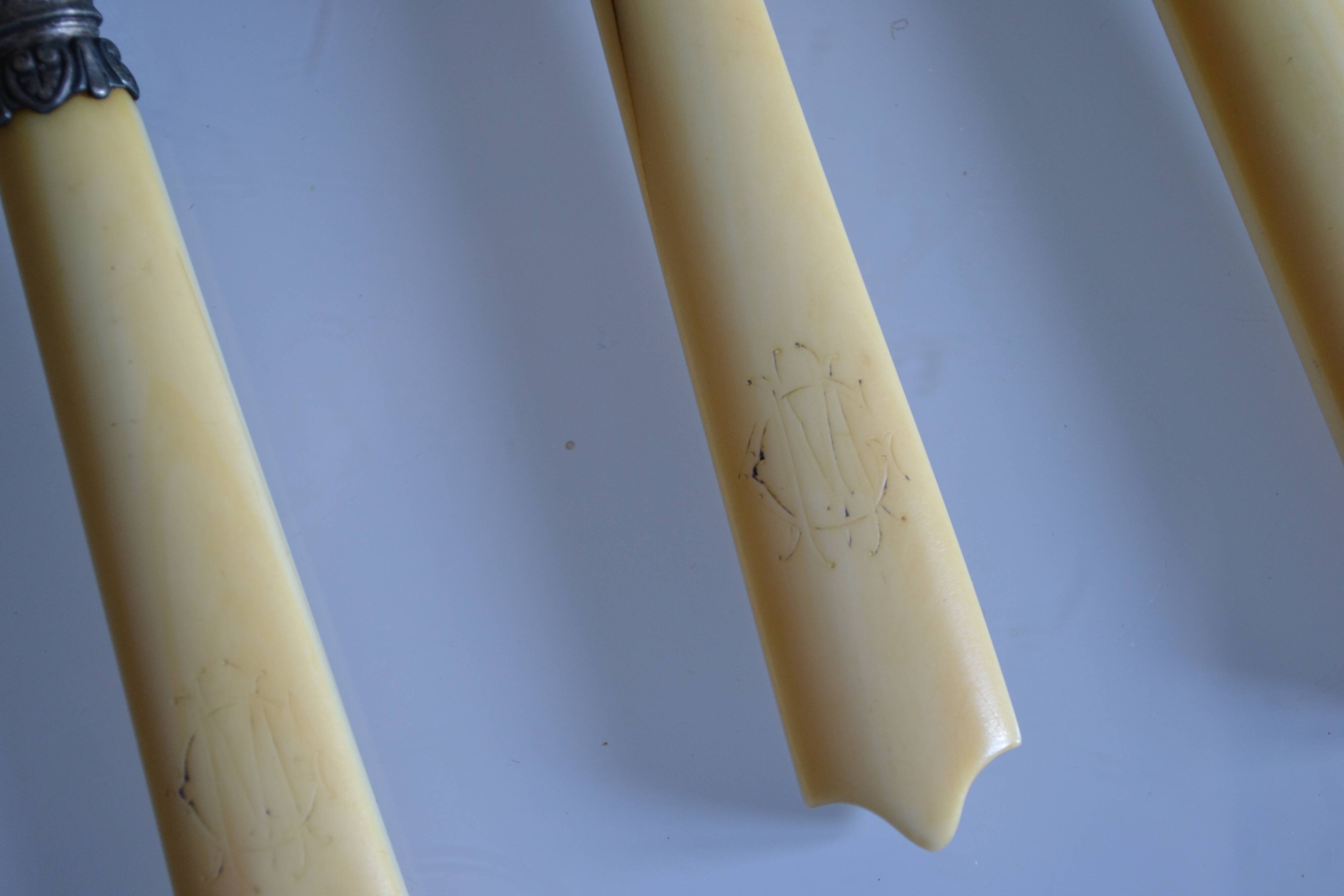11 antique 19th-century table knives with ivory-colored monogram handles
