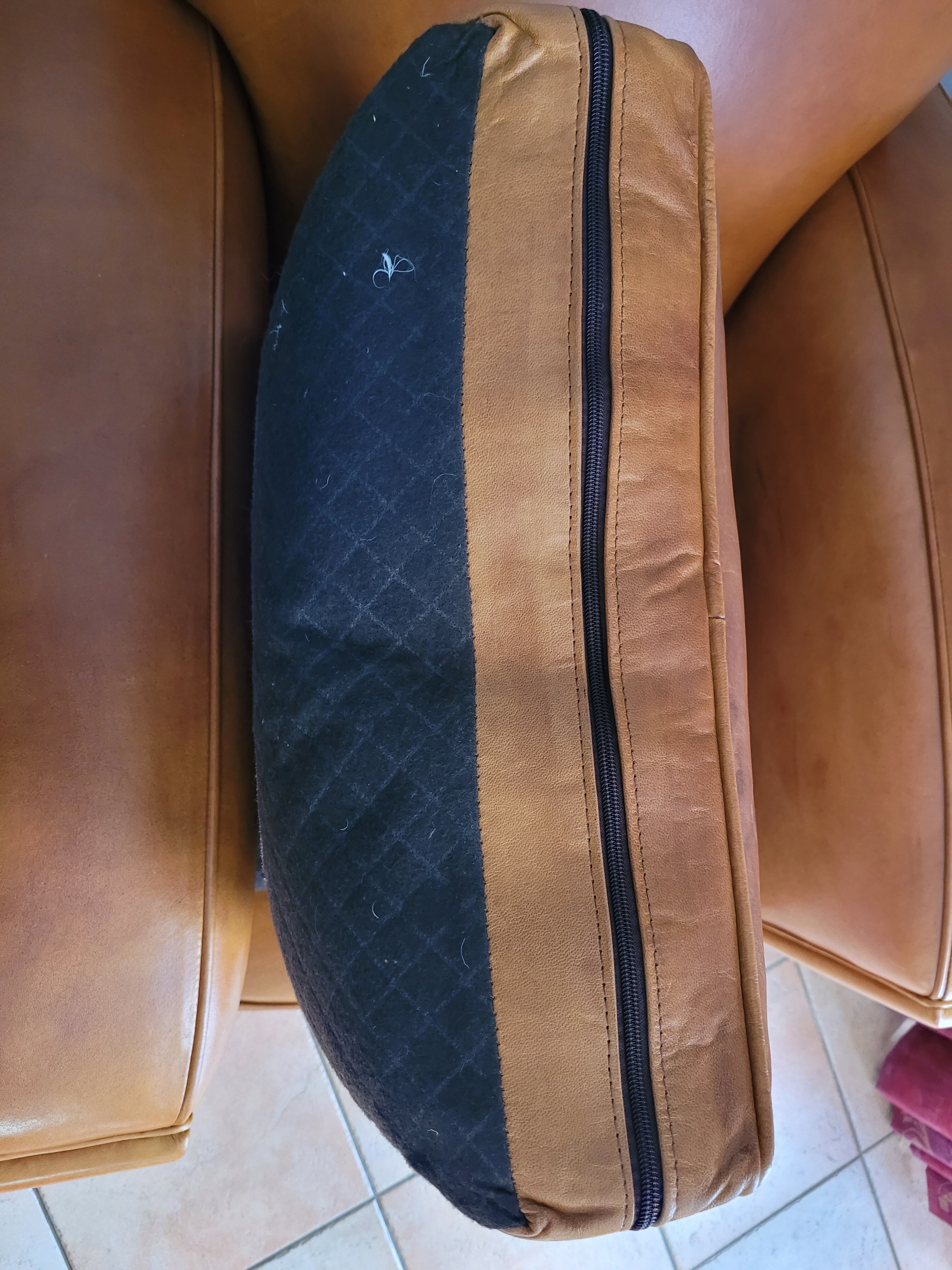 Leather club armchair and its pouf