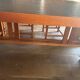 "Frank Lloyd Wright set with a table and its eight chairs."