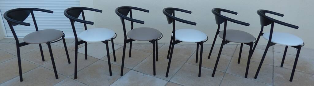 6 gondola-style chairs with a sturdy metal frame and faux leather.