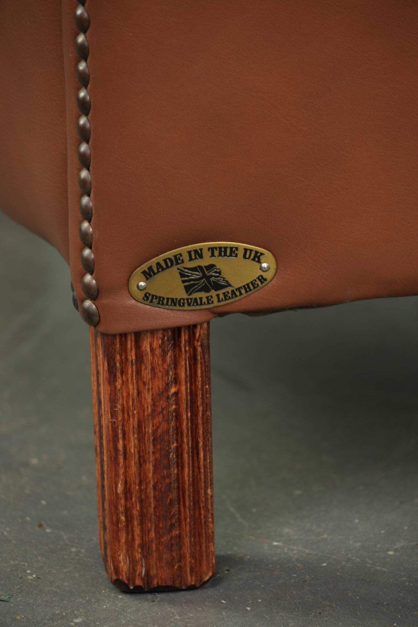 Cowhide club armchair in English style with comfortable seating.