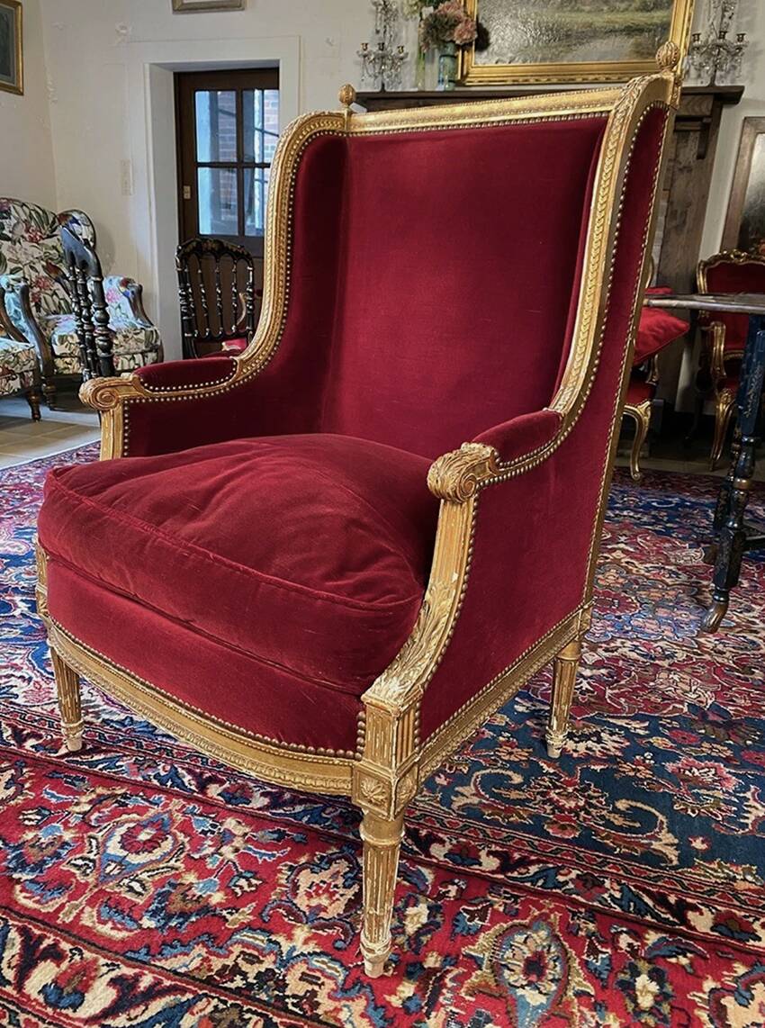 Golden wooden bergère in Louis XVI style upholstered in Bordeaux velvet.