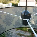 Black cylindrical blind suspension with silver moist print